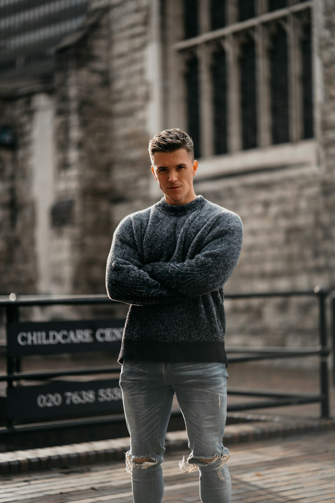 Portrait of a Black British man in his late thirties wearing a grey jumper
