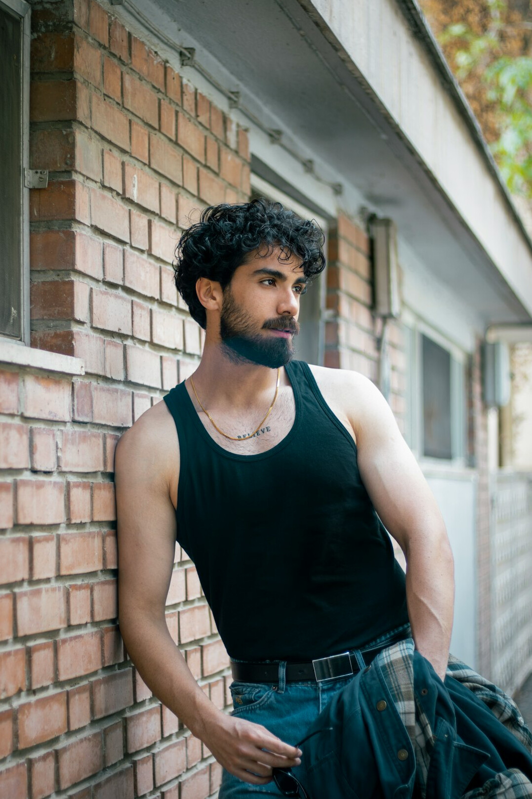 Portrait of a white British man in his forties with short hair and a beard wearing a dark shirt